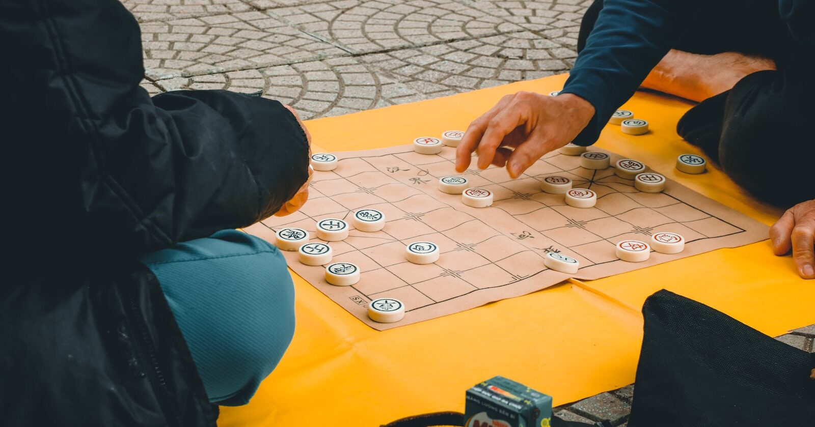 person playing chess on table