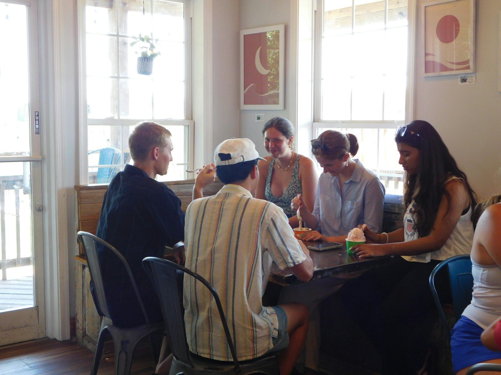 Group of friends sitting around a table indoors.